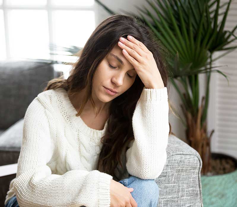 Woman suffering migraine headache